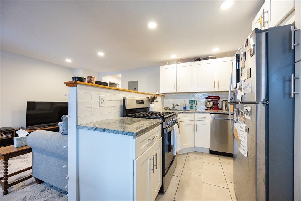 8 Avon Street, Unit 10 Somerville, MA 02143 - Photo 7 of 18 a kitchen with a sink stainless steel appliances and counter space