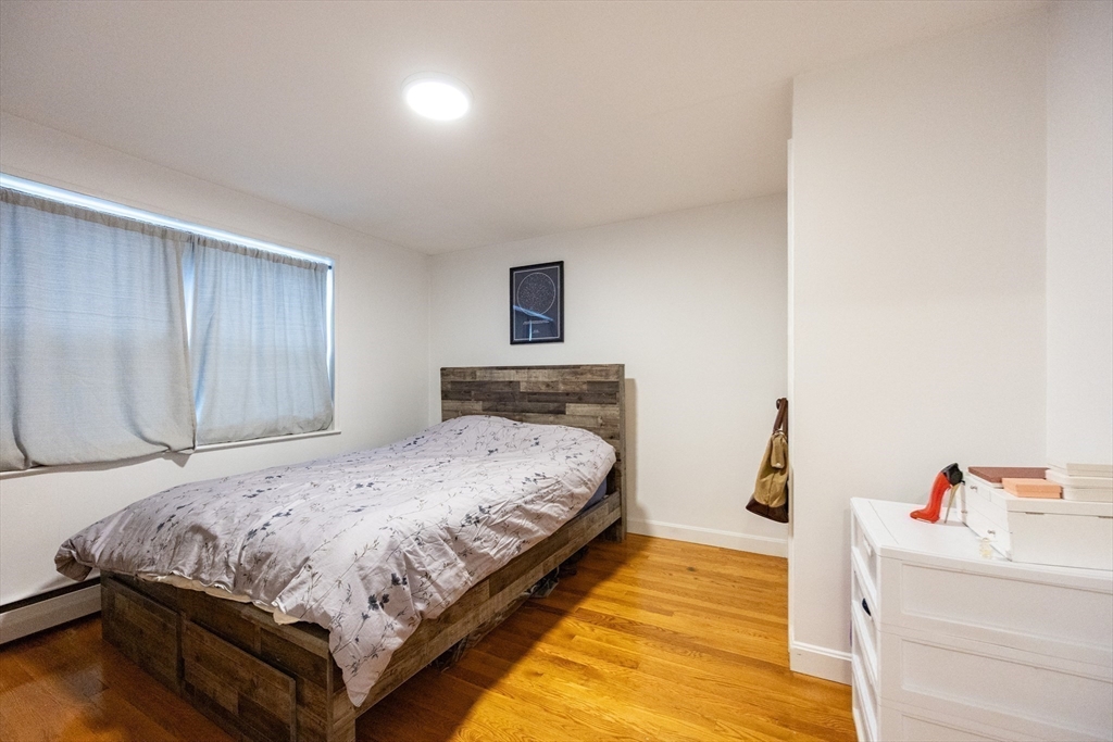 8 Avon Street, Unit 10 Somerville, MA 02143 - Photo 9 of 18 a bedroom with a bed and a flat screen tv