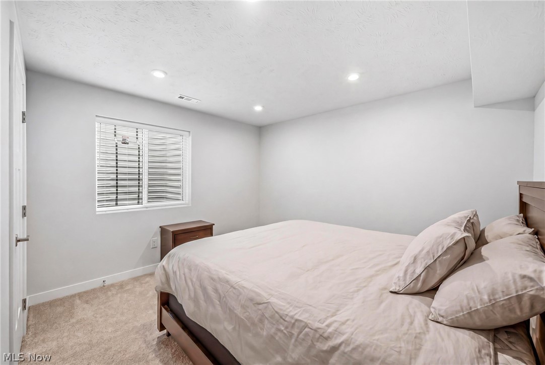 5358 Walnut Rdg Lane Sheffield Lake, OH 44054 - Photo 40 of 50 Carpeted room featuring a white door, recessed lighting, and a horizontal window with blinds