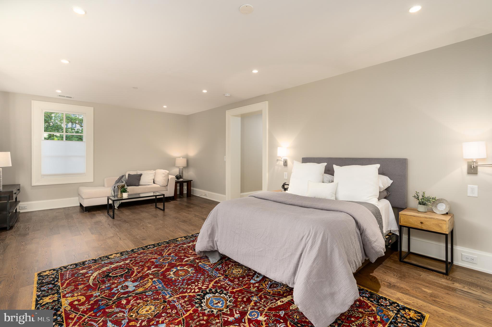 3128 Appleton Street Northwest Washington, DC 20008 - Photo 29 of 80 a spacious bedroom with a bed a couch and a window