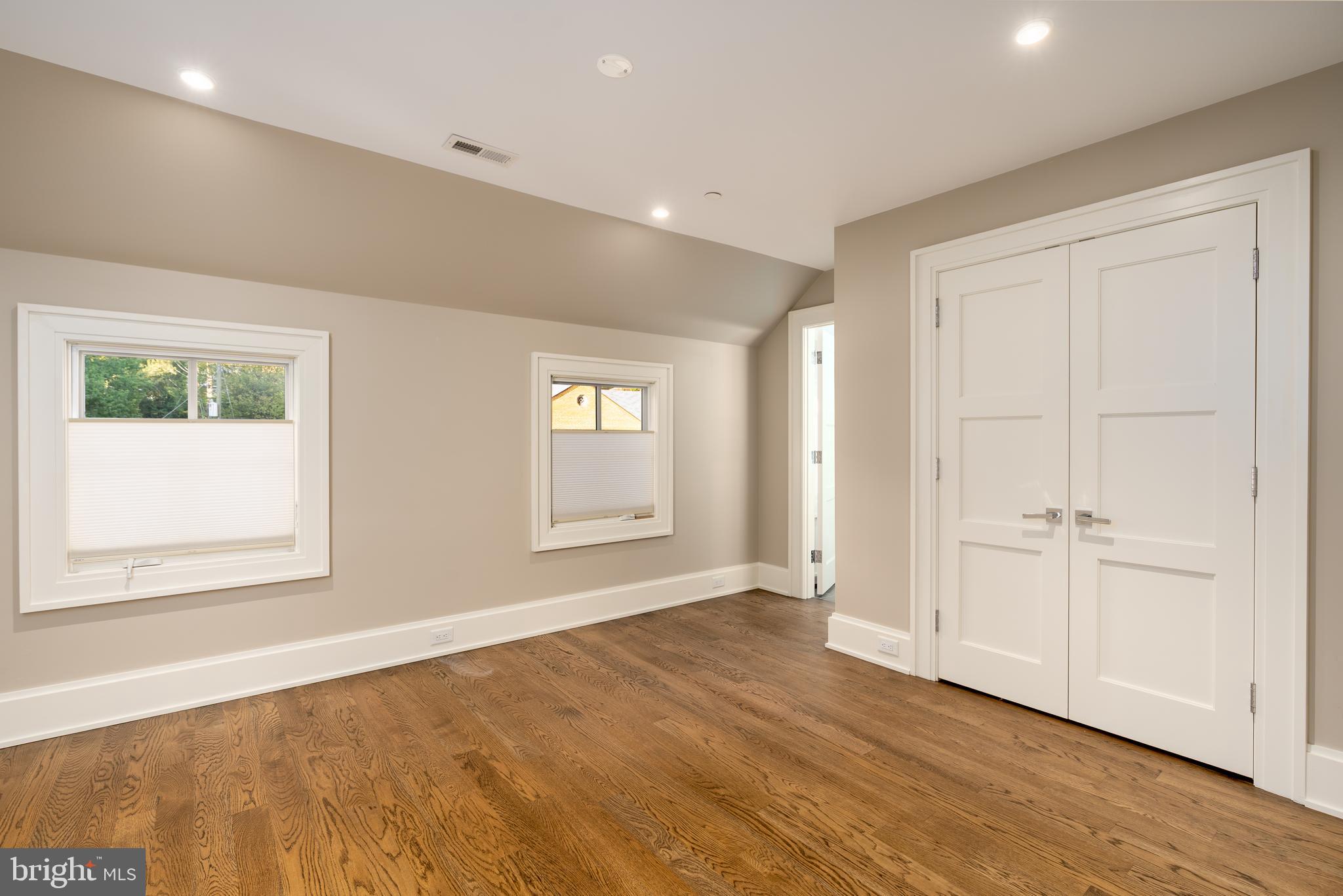 3128 Appleton Street Northwest Washington, DC 20008 - Photo 46 of 80 an empty room with wooden floor and windows