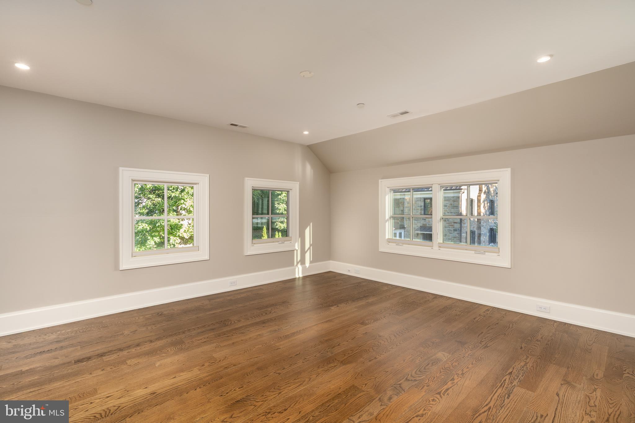 3128 Appleton Street Northwest Washington, DC 20008 - Photo 49 of 80 a view of an empty room with wooden floor and a window