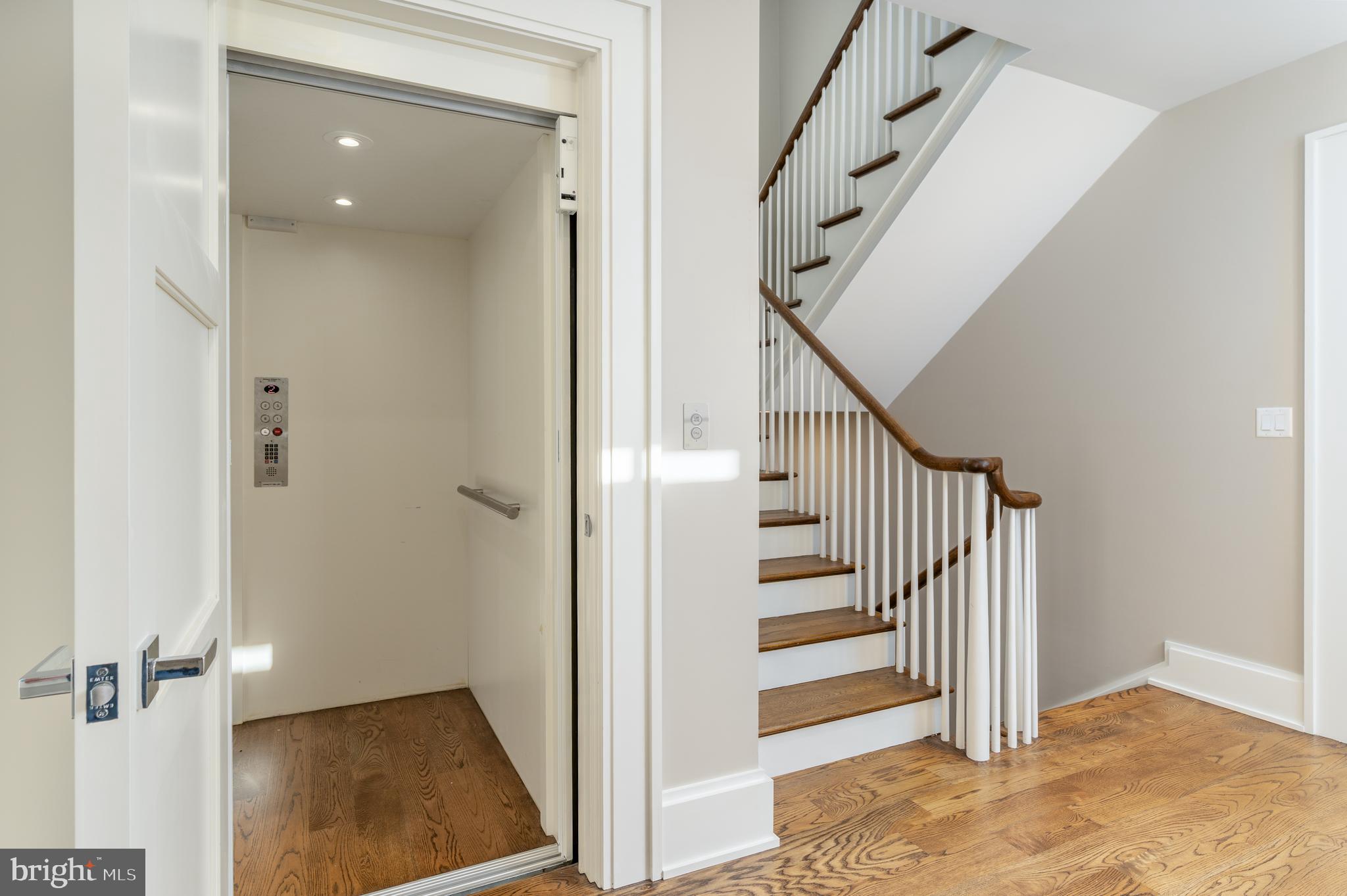 3128 Appleton Street Northwest Washington, DC 20008 - Photo 5 of 80 a view of a hallway with entryway wooden floor and stairs