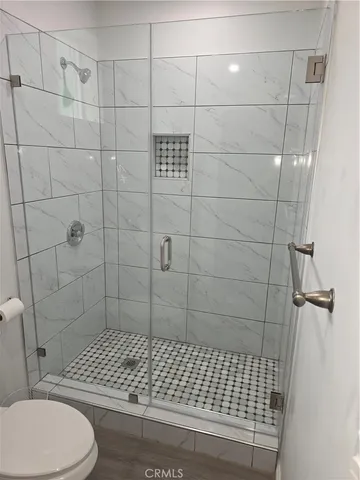 a bathroom with a toilet and a shower