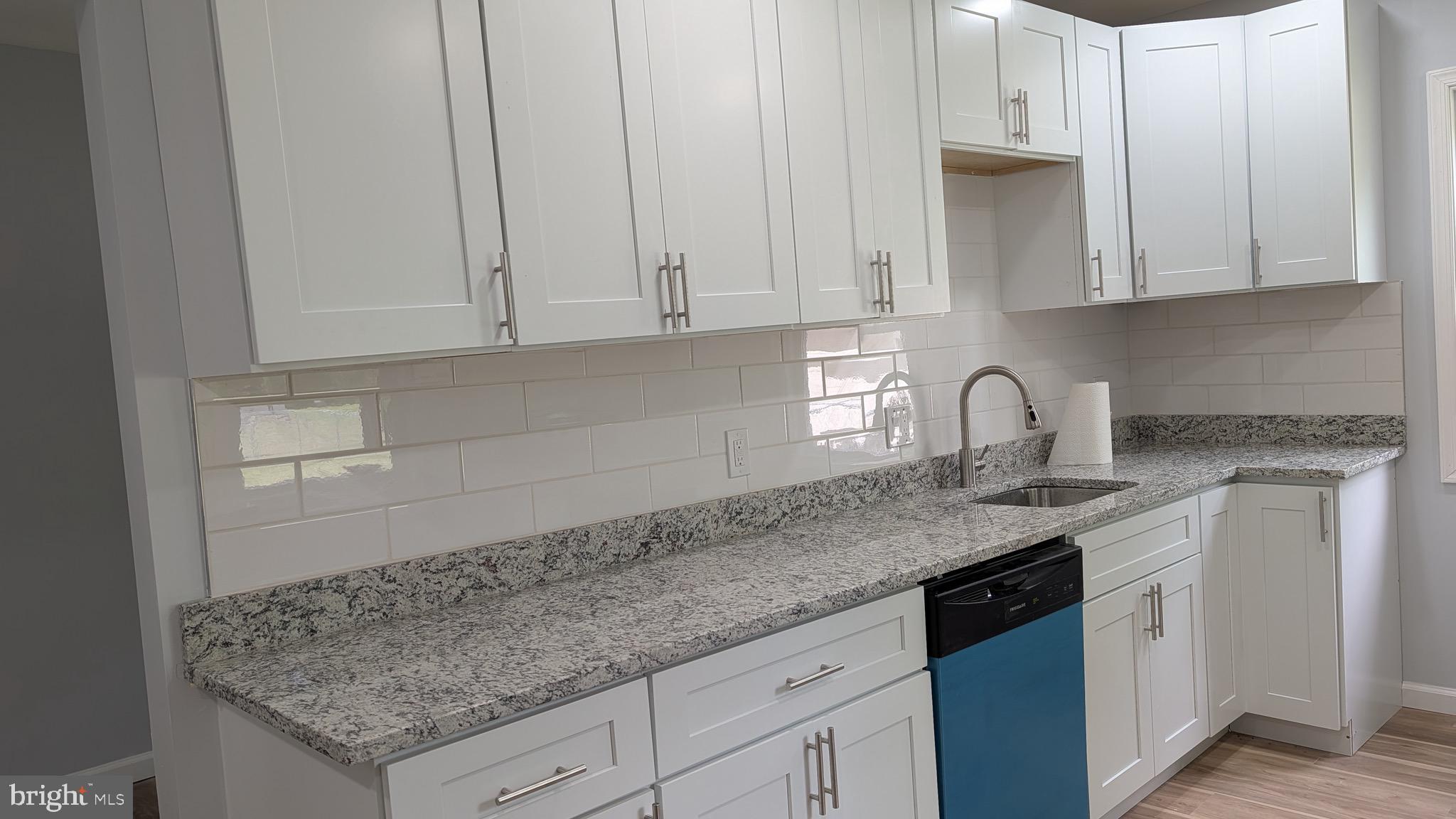 16110 Bealle Hill Road Waldorf, MD 20601 - Photo 11 of 18 a kitchen with granite countertop white cabinets and sink