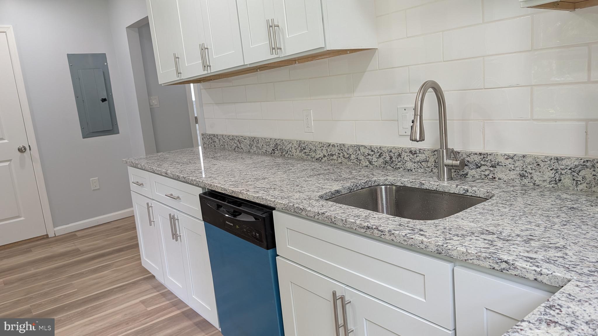 16110 Bealle Hill Road Waldorf, MD 20601 - Photo 14 of 18 a kitchen with stainless steel appliances granite countertop a sink stove and refrigerator