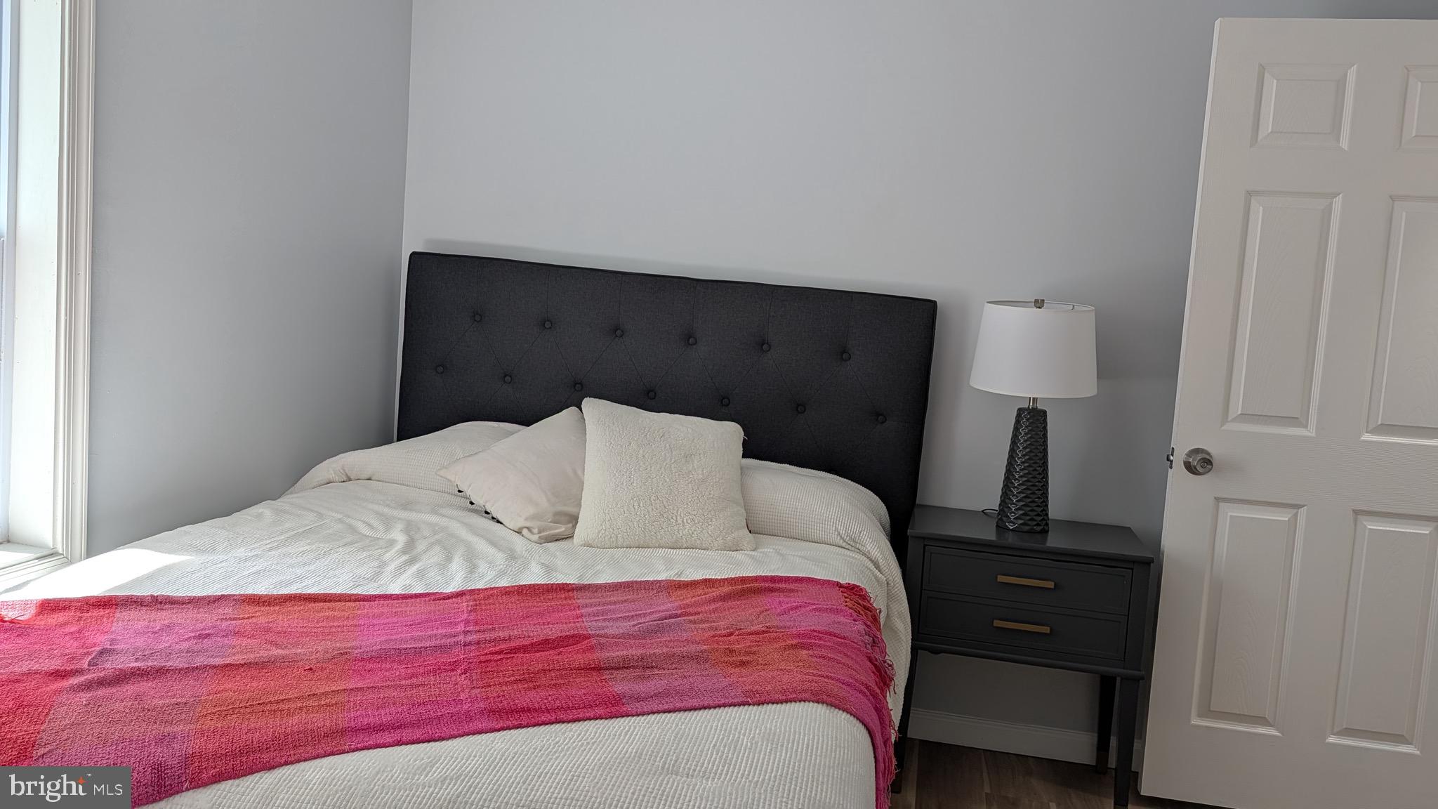 16110 Bealle Hill Road Waldorf, MD 20601 - Photo 16 of 18 a bedroom with a bed and a night stand