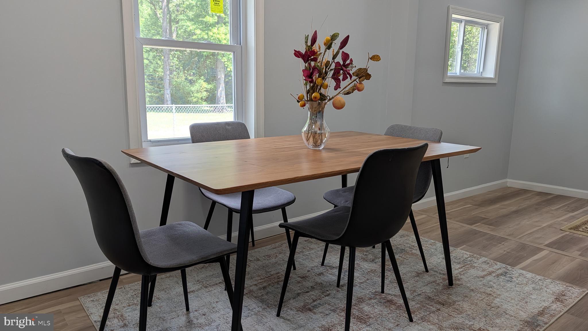 16110 Bealle Hill Road Waldorf, MD 20601 - Photo 7 of 18 a view of a dining room with furniture and wooden floor
