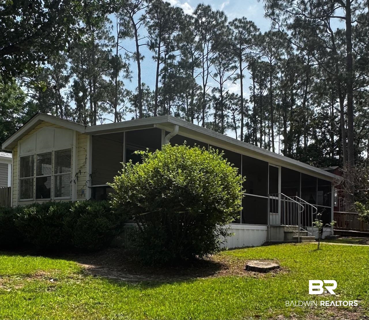 518 Elberta Loop Lillian, AL 36549 - Photo 1 of 38 View of side of home with a sunroom and a yard