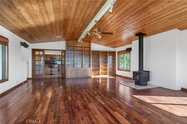 a view of a livingroom with hardwood floor and a workspace