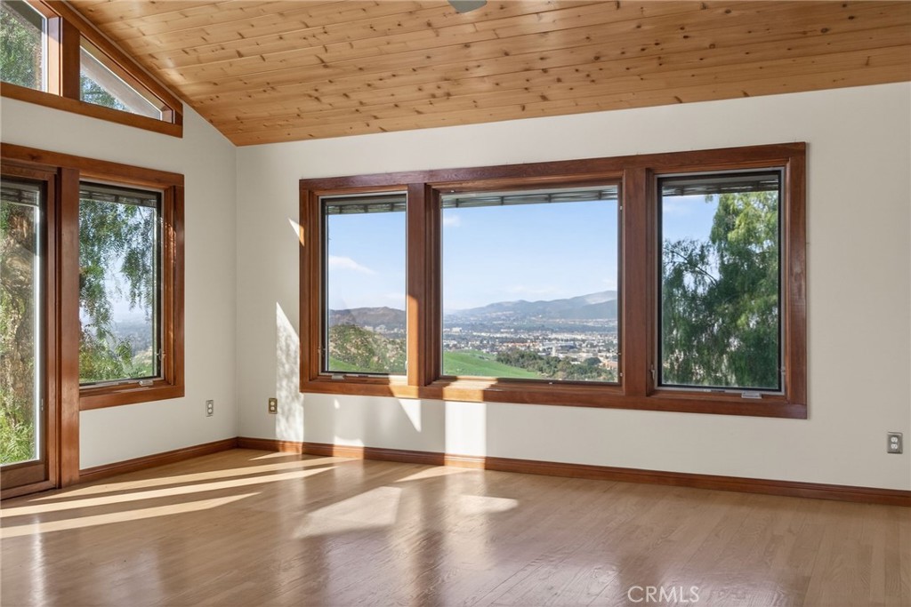 20682 Hill Top Drive Riverside, CA 92507 - Photo 31 of 70 a view of an empty room with wooden floor and a window