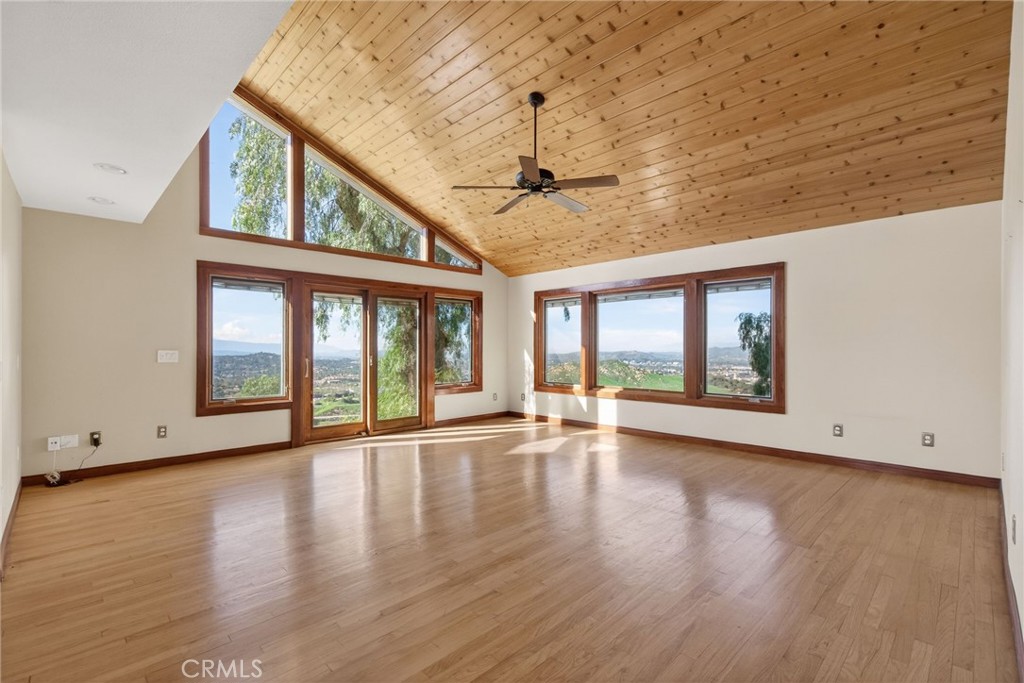 20682 Hill Top Drive Riverside, CA 92507 - Photo 32 of 70 a view of an empty room with wooden floor and a window