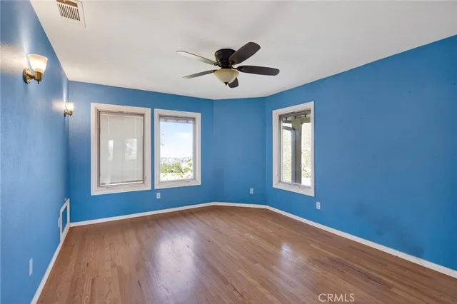 a view of a livingroom with wooden floor and a fireplace
