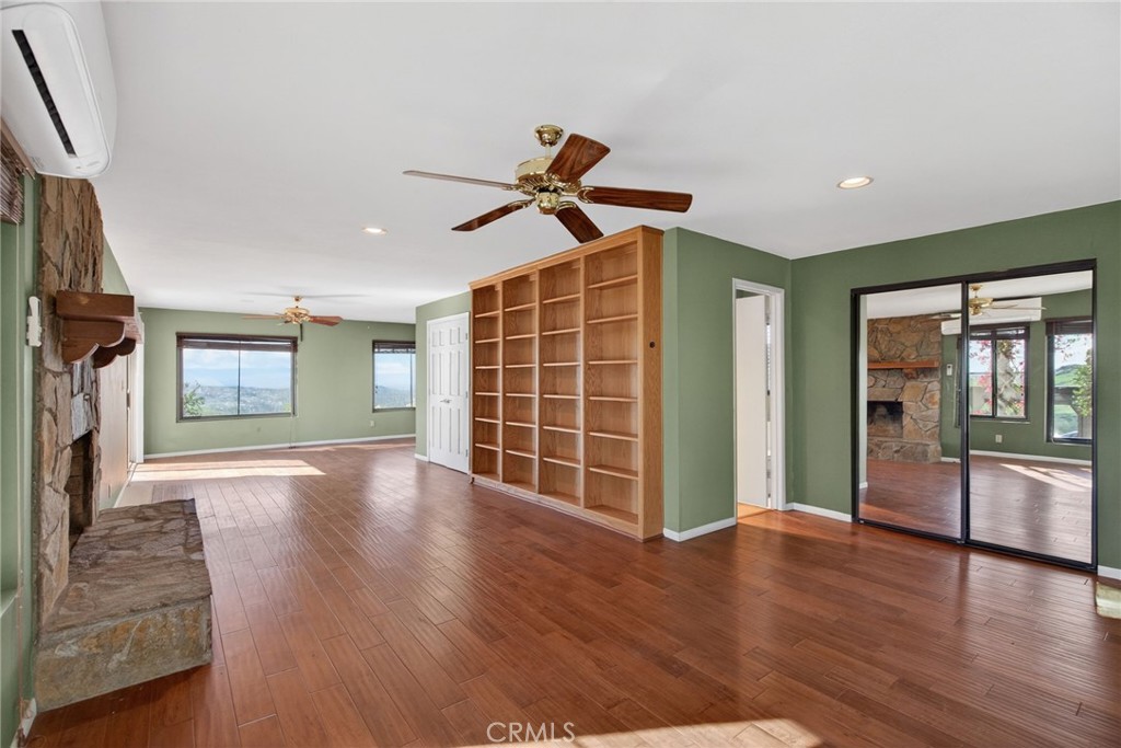 20682 Hill Top Drive Riverside, CA 92507 - Photo 41 of 70 a view of an empty room with window and wooden floor