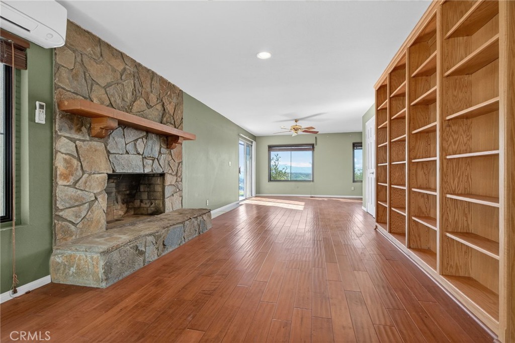 20682 Hill Top Drive Riverside, CA 92507 - Photo 42 of 70 a view of a livingroom with wooden floor and a fireplace