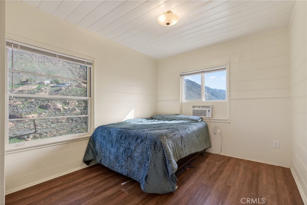 20682 Hill Top Drive Riverside, CA 92507 - Photo 57 of 70 a bedroom with a bed and wooden floor