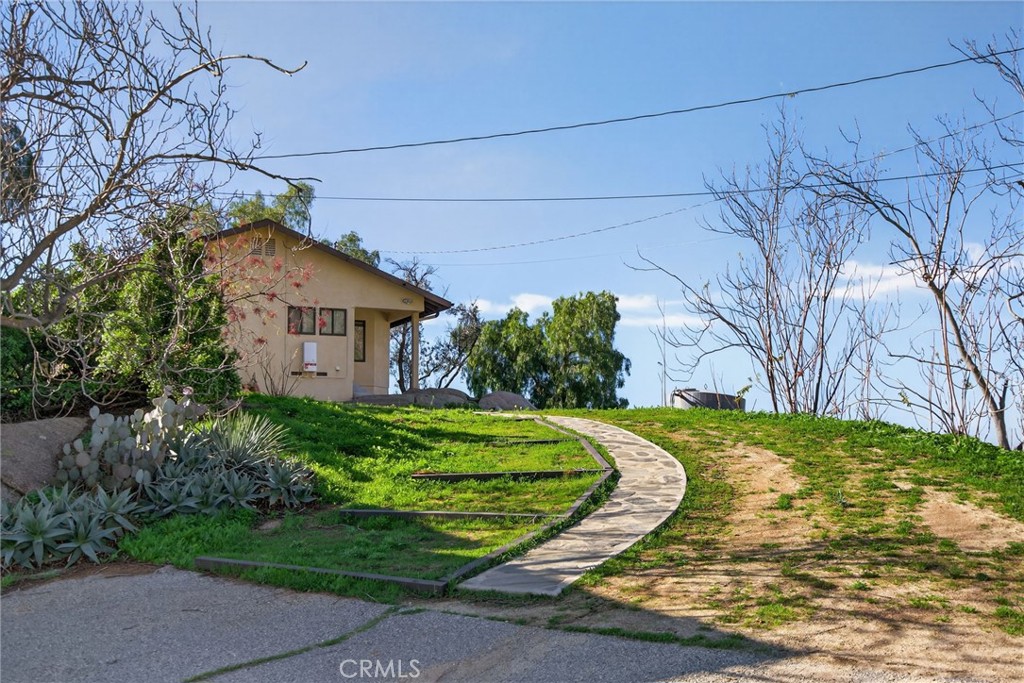 20682 Hill Top Drive Riverside, CA 92507 - Photo 63 of 70 The landscaping has pathways that make access to all parts of the property convenient. This path leads from the main house to the garage and basketball court.