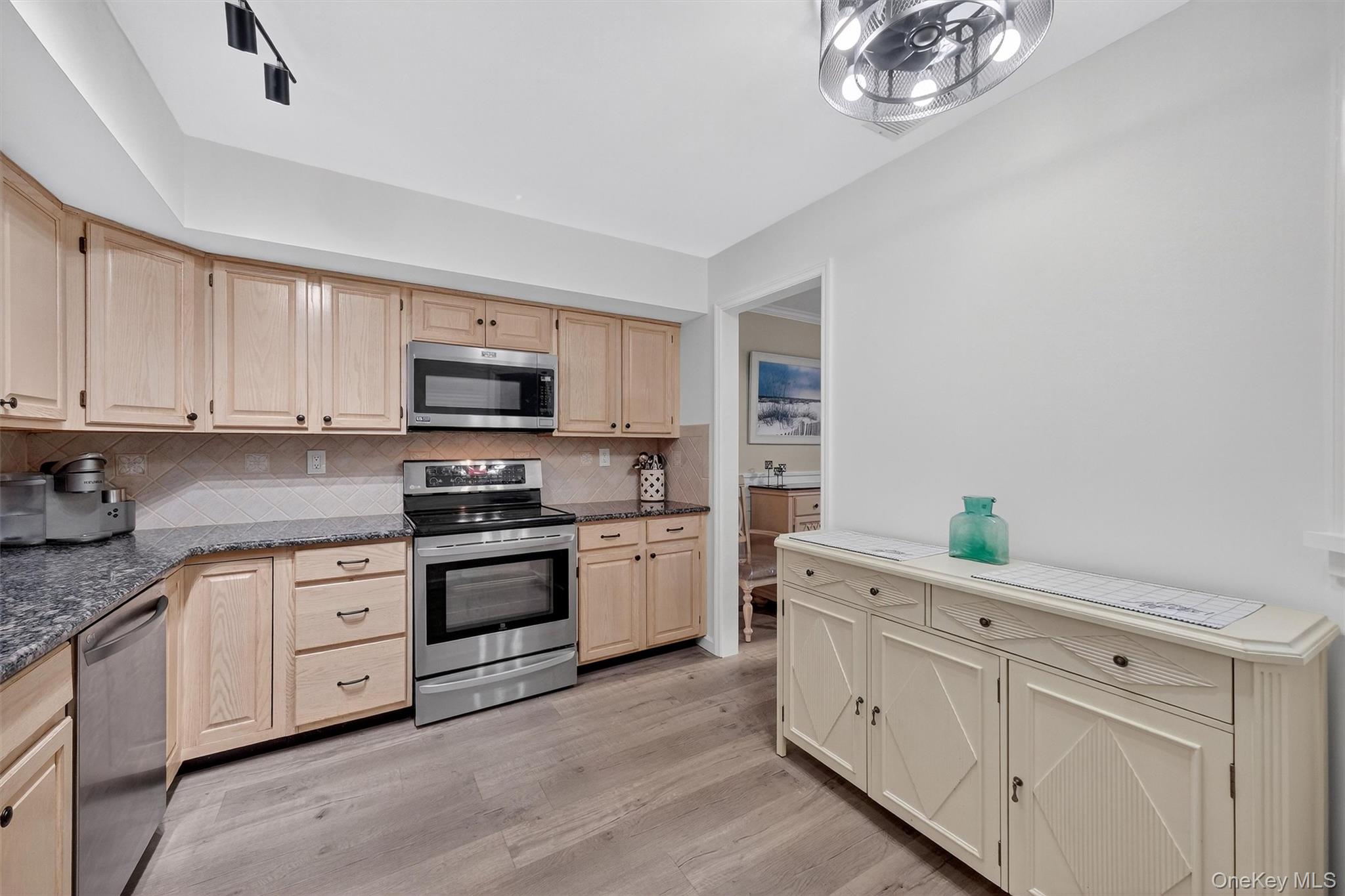 2 Deer Crossing Drive Fishkill, NY 12524 - Photo 20 of 49 a kitchen with white cabinets and stainless steel appliances