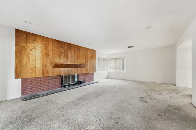 a view of an empty room with a fireplace