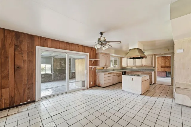 a kitchen with stainless steel appliances kitchen island granite countertop a sink and cabinets