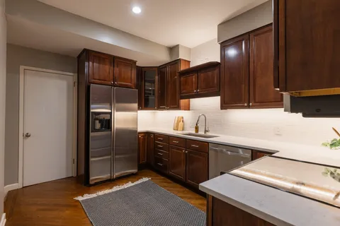 a kitchen with stainless steel appliances a sink and cabinets