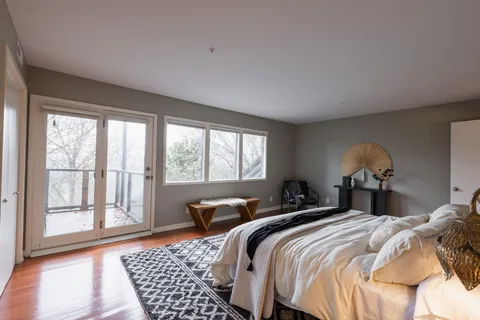 a bedroom with a large bed and a window