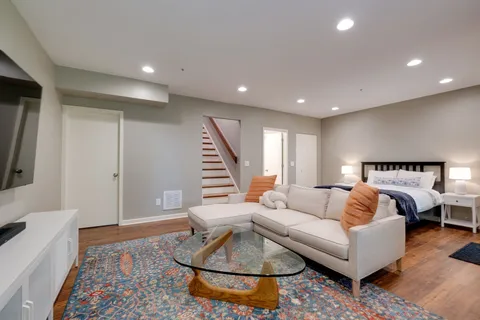 a living room with furniture and a rug