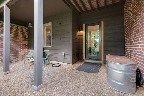 a backyard of a house with barbeque oven