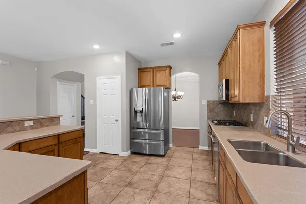 a kitchen that has a sink cabinets counter space and appliances
