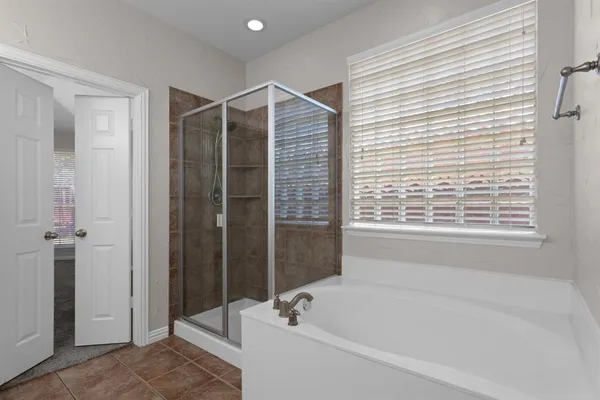 a bathroom with a bathtub and a shower