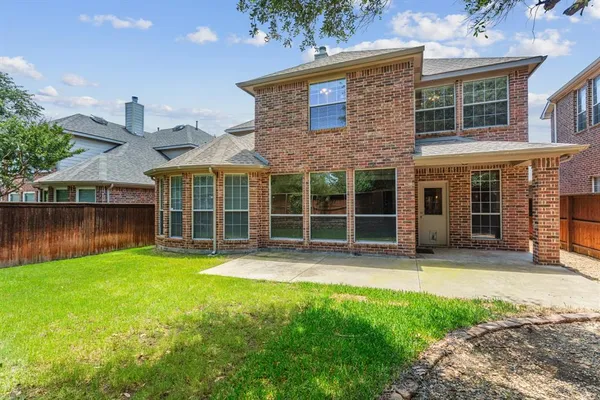 a view of a house with a yard and sitting area