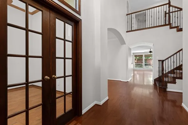a view of entryway with wooden floor and stairs