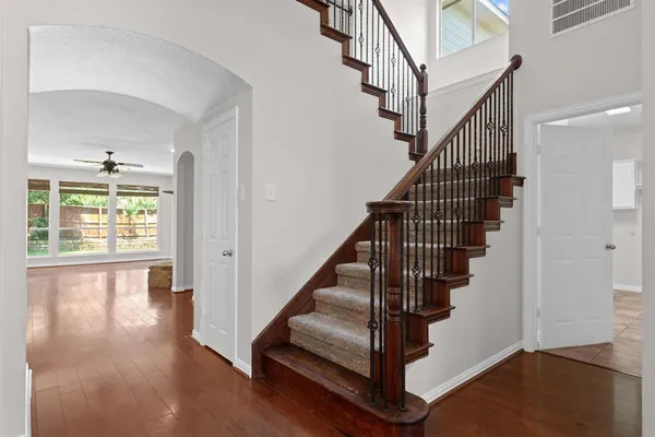 a view of entryway with wooden floor and stairs