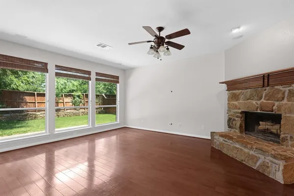 a living room with a fireplace and a floor to ceiling window