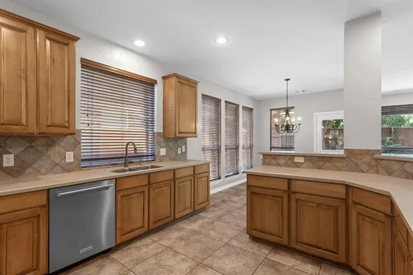 a large kitchen with stainless steel appliances granite countertop a sink and cabinets