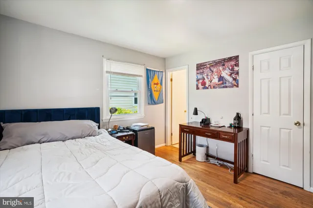 a bedroom with a bed and a workspace