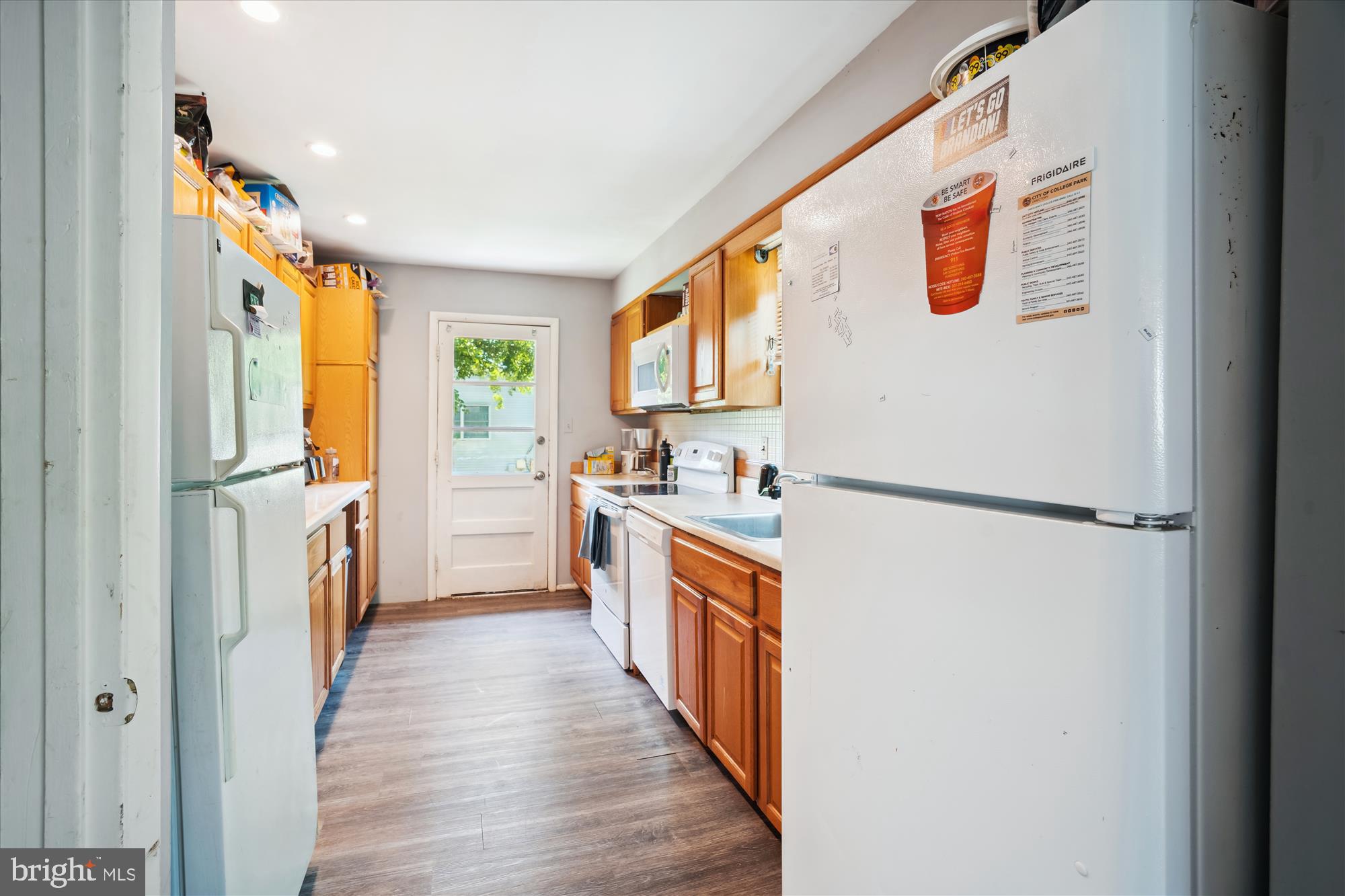 4701 Norwich Road College Park, MD 20740 - Photo 2 of 16 a kitchen with a refrigerator a sink and dishwasher with wooden floor
