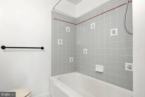 a bathroom with a shower and a toilet