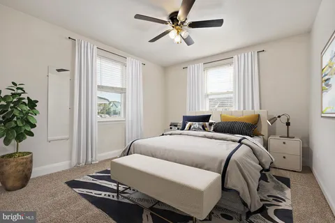 a bedroom with a bed and a potted plant