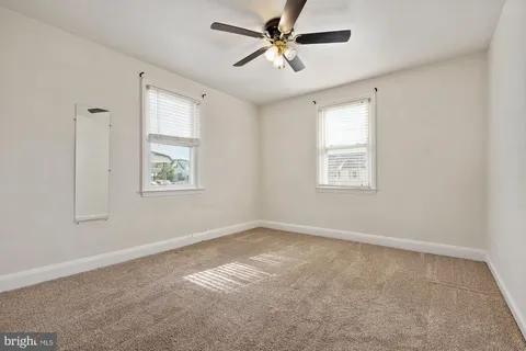 a view of room with a ceiling fan and window