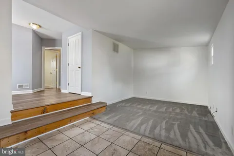 a view of room with wooden floor