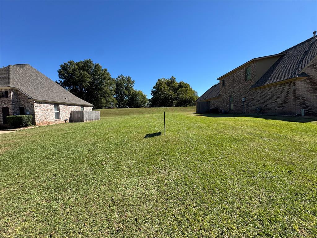 0 Bevly Bossier City, LA 71111 - Photo 1 of 3 a house with green field in front of it