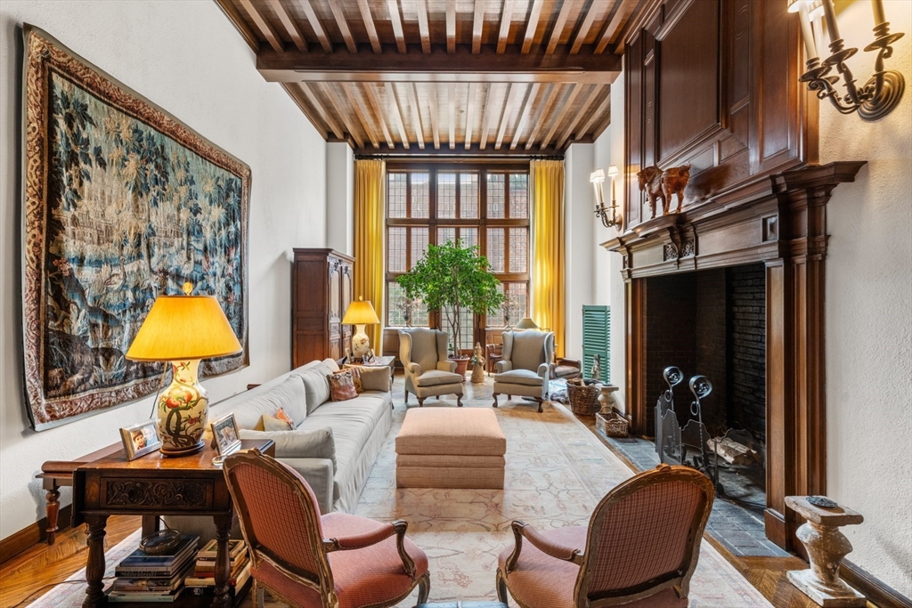 a living room with furniture a fireplace and a window