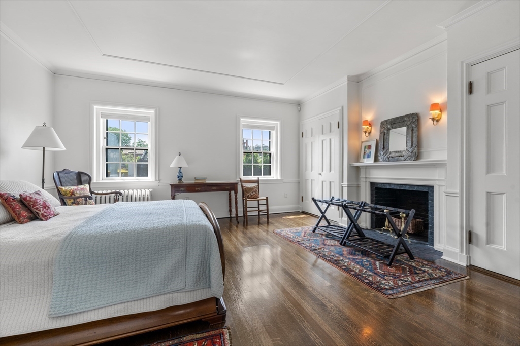 32 Lime Street Boston, MA 02108 - Photo 15 of 30 a bedroom with a bed a fireplace and windows