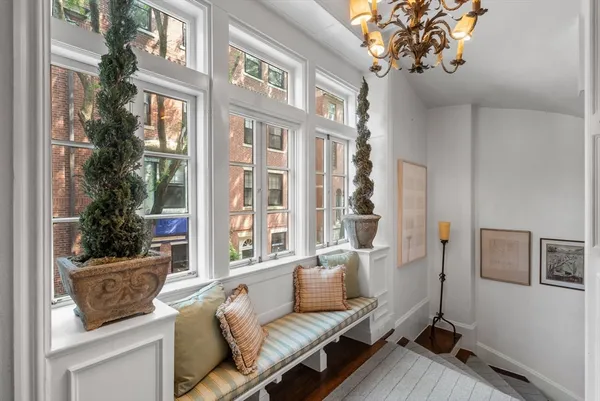 a bedroom with a bed a fireplace and windows