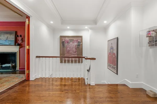 a view of a hallway with entryway wooden floor and front door