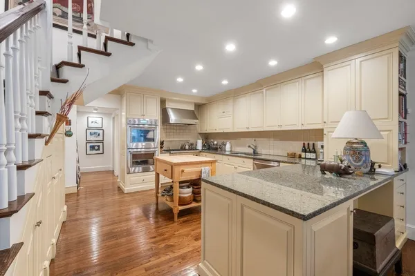 a kitchen with a table chairs refrigerator and cabinets