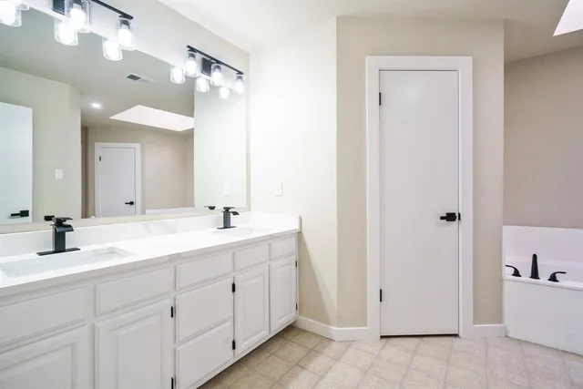 a bathroom with a bathtub and a sink