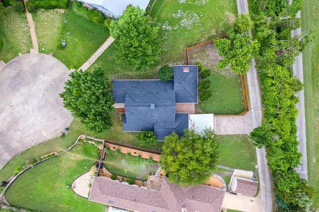an aerial view of residential houses with outdoor space and river