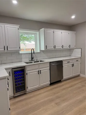 a kitchen with stainless steel appliances granite countertop a sink stove and cabinets